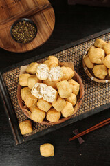 Crispy Fried Tofu Puffs in Wooden Bowls with Asian Table Setting