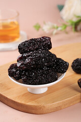 Dried Black Jujube Dates from Shaanxi Province China Traditional Asian Superfood Snack on Wooden Board