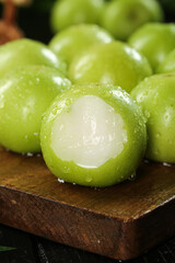 Fresh Green Dates with White Flesh on Wooden Board - Organic Fruit Showcase