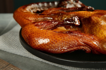 Whole Roasted Farmhouse Goose with Golden Crispy Skin on Dark Plate Traditional Cured Poultry Dish