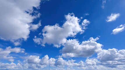 Fototapeta premium Fluffy clouds in a radiant blue sky drift by with warmth and depth