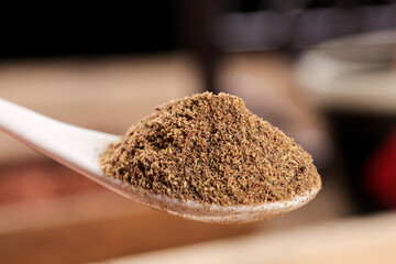 Fine Powdered Barbecue Seasoning with Peppercorns on Wooden Spoon - Quality Food Ingredient