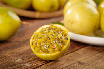 Fresh Golden Passion Fruit with Juicy Pulp and Seeds on Wooden Board