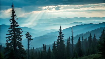 Obraz premium Misty mountain landscape at dawn with layers of peaks and valleys in soft blue hues