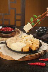 Asian Tofu Platter with Chopsticks and Hot Chili Peppers on Traditional Wooden Board