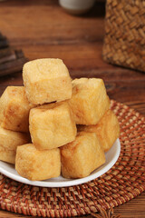 Crispy Golden Fried Tofu Cubes on Bamboo Placemat - Traditional Asian Cooking Ingredient