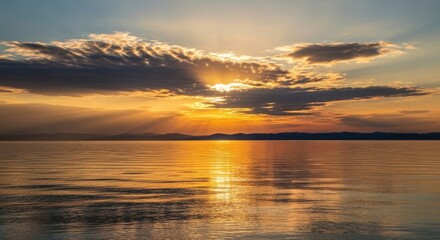 Dramatic sunset over calm water with sun rays breaking through clouds isolated on white background