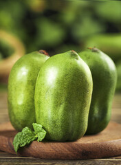 Fresh Green Mini Kiwi Fruits on Wooden Board with Mint Leaf - Healthy Organic Produce