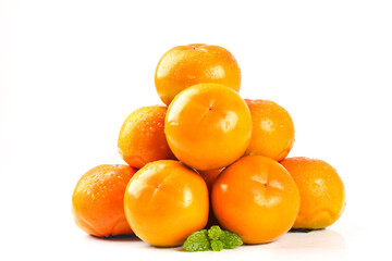 Fresh Orange Persimmons Pyramid Stack with Mint Leaves on White Background
