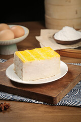 Hubei Traditional White Steamed Cake with Golden Topping - Chinese Specialty Dessert on Wooden Board