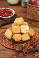 Delicious Golden Fried Tofu Cubes in Wooden Bowl with Asian Spices and Traditional Table Setting