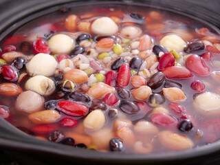 Traditional Laba Congee Chinese Porridge with Mixed Grains and Beans Cooking in Pot
