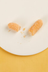 Traditional Beijing Glutinous Rice Dim Sum Guo Sticks with Snowflake Coating on Yellow Background