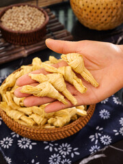 Hand Holding Dried Bean Curd Knots Traditional Asian Cooking Ingredient Handmade Food Preparation
