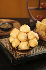 Golden Fried Tofu Puffs in Traditional Wooden Bowl - Asian Cuisine Preparation