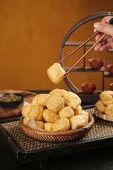 Golden Fried Tofu Cubes with Chopsticks - Traditional Asian Soybean Food Preparation