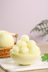 Fresh Melon Balls in Natural Bowl - Healthy Summer Fruit Dessert with Wicker Basket and Plant Decor