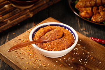 Spicy Chili Powder in Bowl with Wooden Spoon for Hot Pot Dipping Sauce Base