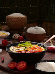 Asian rice meal with five flavors stir-fry pot and preserved vegetables on wooden table
