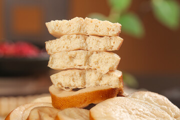 Handmade Tofu Rounds and Dried Bean Rolls Stack on Wooden Platter - Vegetarian Protein Food Ingredients