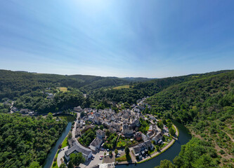 Esch-sur-Sure, Wiltz, Grand-Duche de Luxembourg, August 10, 2025, This stunning aerial view captures a picturesque village perfectly nestled amidst scenic hills and a winding river