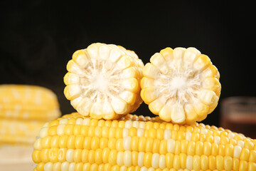 Fresh Sweet Corn Cobs Cut in Half Showing Yellow Kernels on Wooden Table