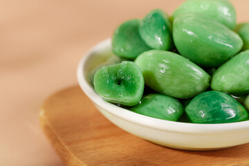 Green Cured Olives in Bowl on Wood Table - Mediterranean Food Photography
