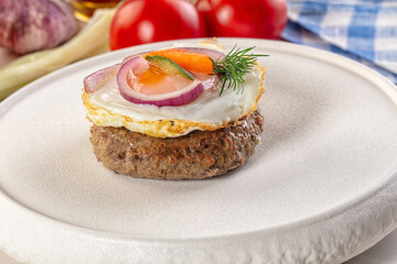 Beefsteak chop with roasted egg
