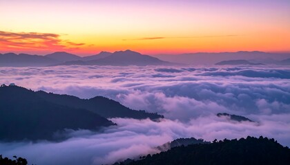 Vibrant sunset over a sea of clouds, mountain silhouettes