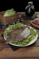 Freshly Caught Whole Arctic Flounder Seafood on Table with Lettuce Garnish
