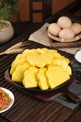 Handmade Lotus Leaf Shaped Yellow Cakes in Cast Iron Pan Traditional Asian Culinary Culture Food Photography