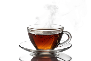 Steaming hot tea in a clear glass cup on a saucer