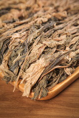 Traditional Dried Salted Cabbage Leaves on Wooden Board - Fermented Asian Food Ingredient