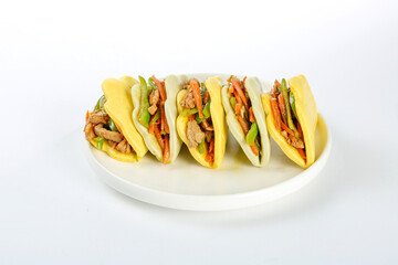 Gourmet Asian Steamed Buns with Spiced Shredded Pork and Vegetables on White Plate