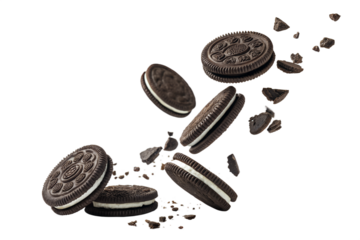 Delicious oreos and cookie crumbs in mid air against a black background