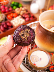 Traditional Compressed Tea Cake Display with Fireplace Setting and Warm Beverage Preparation