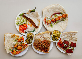 Delicious meat kebab with fresh vegetable salad served with variety of Turkish dishes and appetizers. Top view of assorted Turkish food and meze, tasty and healthy Mediterranean cuisine. Top view.