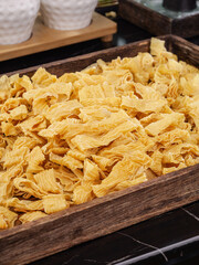 Dried Tofu Bean Curd Skin Sheets in Wooden Basket Traditional Asian Food Ingredient Market Display