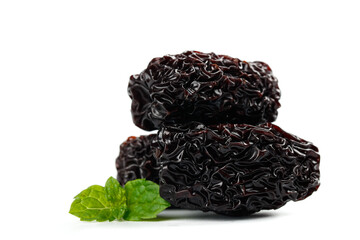 Black Jujube Dates from Xinjiang China with Fresh Mint Leaf on White Background