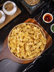Handmade Dried Bean Curd Skins in Wicker Basket with Traditional Asian Cooking Ingredients