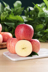 Fresh Red Fuji Apples from Luochuan China with Sliced Half on White Plate