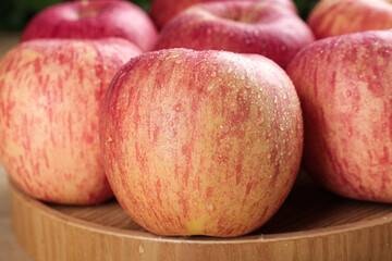 Fresh Red Fuji Apples from Luochuan with Water Droplets on Wooden Display