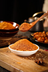 Red Chili Powder Spice Seasoning in Wooden Spoon - Asian Cooking Ingredients on Rustic Board