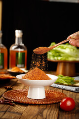 Sprinkling Sichuan Hot Spice Powder Seasoning for Asian Cooking with Fresh Vegetables