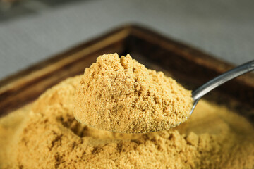 Powdered Ginger Spice in Wooden Bowl - Healthy Natural Seasoning for Cooking