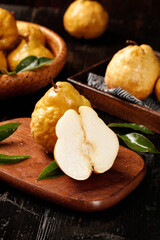 Fresh Yantai Asian Pears on Wooden Board - Organic Golden Fruit with Natural Texture and Green Leaves