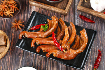 Spicy Marinated Duck Paws Traditional Asian Delicacy with Chili Peppers and Star Anise on Wooden...