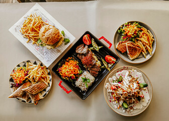 Delicious meat kebab with fresh vegetable salad served with variety of Turkish dishes and appetizers. Top view of assorted Turkish food and meze, tasty and healthy Mediterranean cuisine. Top view.