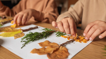 Children creating art with leaves and twigs