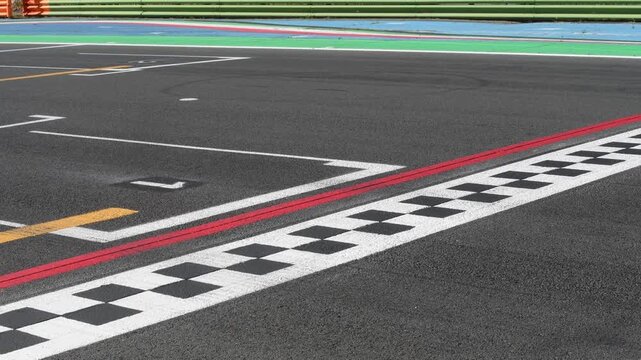 Racing car crossing finish checkered line on asphalt track, original sound engine
